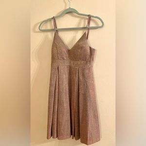 This dress by Haute Monde is size small and a shimmering champagne color.